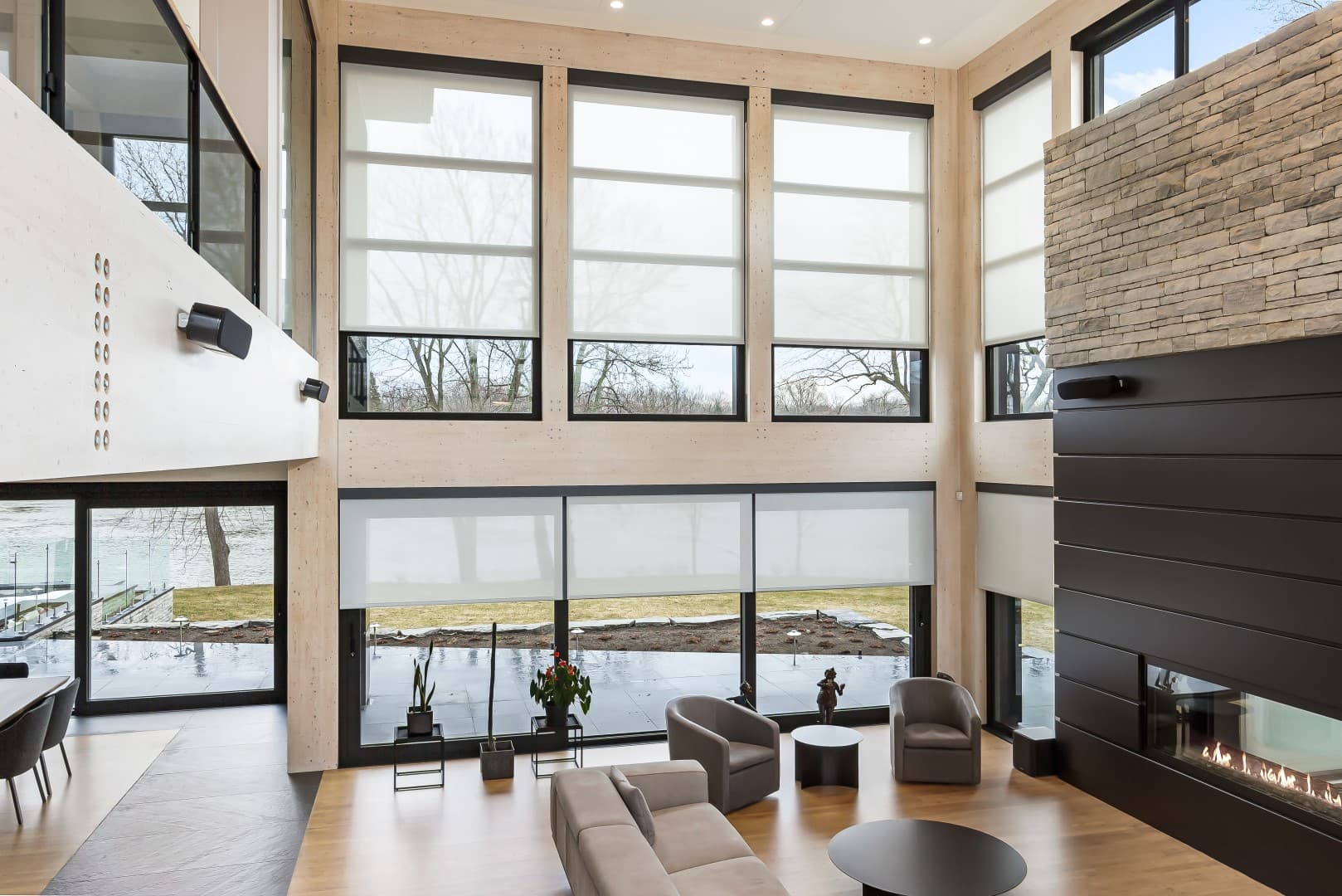 Motorized shades on a full-height window with a city view